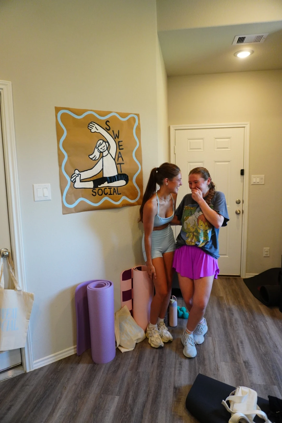 Friends laughing together after a Sweat Social